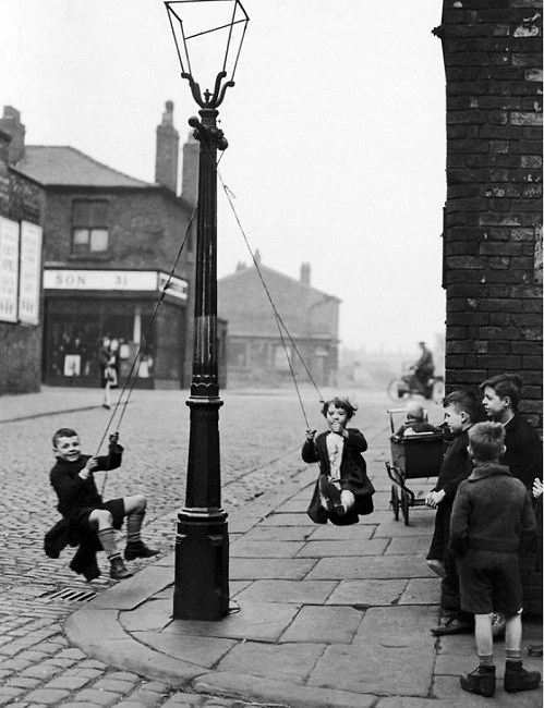 Kids swinging off in the street